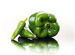 Fresh green bell pepper and chili peppers on white background.