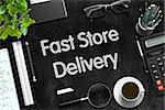 Business Concept - Fast Store Delivery Handwritten on Black Chalkboard. Top View Composition with Chalkboard and Office Supplies on Office Desk. 3d Rendering.