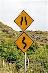 Signs of winding road and bottleneck on a Irish road