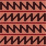 Abstract knitting ornamental seamless vector pattern with zigzag lines as a knitted fabric texture in warm colors