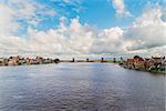 traditional Dutch windmills of Zaanse Schans over river at summer day, Netherlands,