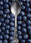 Blueberries around spoon close up photo. Natural healthy food. Still life photography