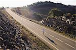 Runner running on road, high angle view