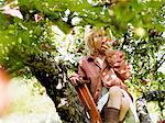 Girl on ladder eating apple, Varmdo, Uppland, Sweden