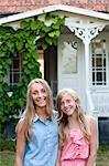 Sisters together in front of house, Oland, Sweden