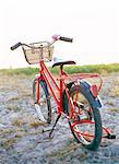 A child's bicycle on a beach.