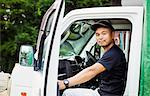 A young man sitting in a truck at a commercial farm in Japan.