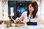 Saleswoman in a shop selling Edo Kiriko cut glass in Tokyo, Japan.