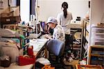 A mature woman at a desk in the office of a fast food unit and noodle production factory.