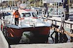 Man standing on boat in sea