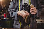 Shoemaker polishing a shoe in workshop