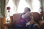 Couple embracing each other in living room at home