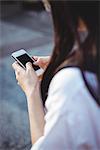 Close-up of woman text messaging on mobile phone