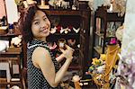 Portrait of smiling woman selecting a cup in a antique jeweler shops