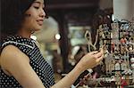Stylish woman selecting jeweler in a antique jeweler shops