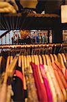 Woman selecting a clothes on hanger at apparel store