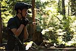 Male athletic wearing bicycle helmet in forest