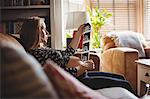 Pregnant woman looking at a sonography in living room at home