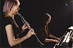 Students playing clarinet and piano at music school