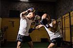 Two thai boxer practicing boxing in fitness studio