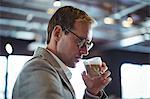 Confident businessman having coffee at café