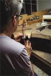 Close-up of craftswoman working in workshop