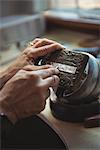 Close-up of craftswoman working in workshop