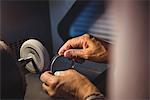 Hands of craftswoman working on a machine in workshop