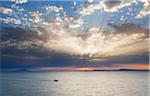 Boat cruising on the Gulf of Naples at sunset on the coast of Sorrento Peninsula in Campania, Italy