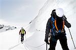 Rear view of mountaineers ski touring on snow-covered mountain, Saas Fee, Switzerland