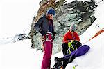 Mountaineers preparing equipment on snow-covered mountain, Saas Fee, Switzerland