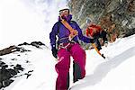 Mountaineers descending snow-covered mountain, Saas Fee, Switzerland