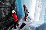 Couple in cave ice climbing, Saas Fee, Switzerland