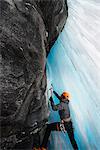 Man in cave ice climbing, Saas Fee, Switzerland