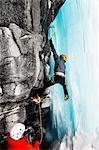 Ice climbers climbing on rock face