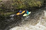 High angle view of two kayakers paddling River Dee rapids, Llangollen, North Wales