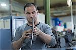 Man checking rotary blade in workshop