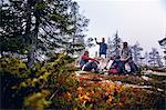 Hikers relaxing and chatting in park, Sarkitunturi, Lapland, Finland