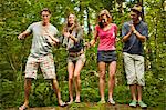 Friends dancing in a forest.