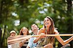 Four friends having fun while canoeing.