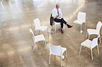 Businessman with digital tablet waiting for circle meeting