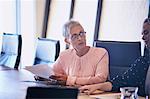 Attentive businesswoman listening in conference room meeting