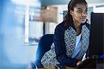 Businesswoman working at laptop in office