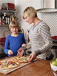 Mother and daughter preparing food in kitchen