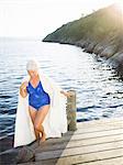 A senior woman on a jetty.
