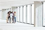 Full length of business people having discussion in empty office