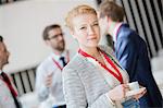 Portrait of confident businesswoman holding coffee cup at lobby in convention center