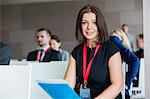 Portrait of confident businesswoman sitting in seminar hall