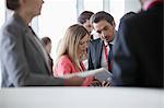 Business people using digital tablet in convention center