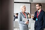 Business people discussing in seminar hall